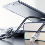 Medical stethoscope and laptop and books