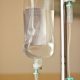 iv bag hanging on a metal pole in the room