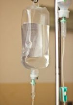 iv bag hanging on a metal pole in the room