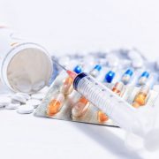 Syringe with glass vials and medications pills