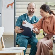 vet talking to dog owner