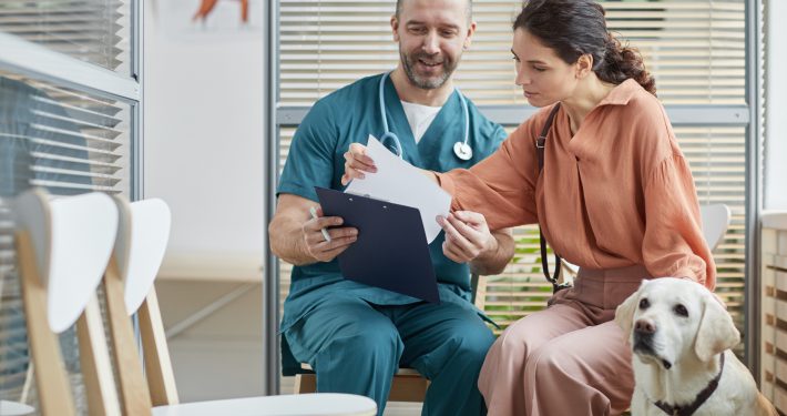 vet talking to dog owner